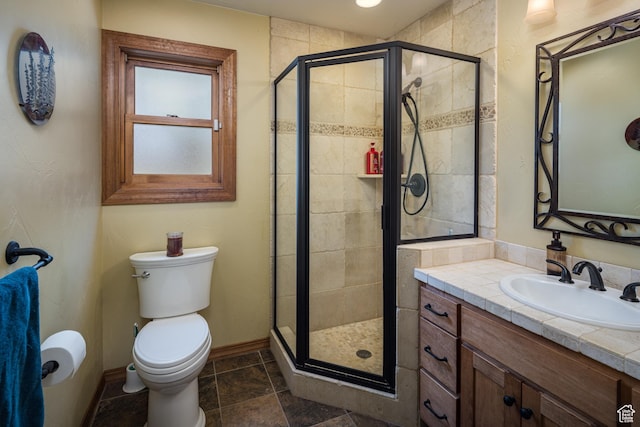 3270 E Rim Vistas Cir, Moab, UT 84532 - bathroom featuring vanity, baseboards, a shower stall, and toilet