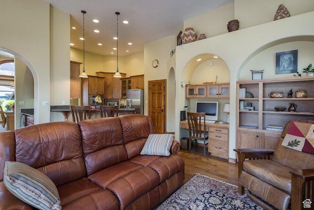 3270 E Rim Vistas Cir, Moab, UT 84532 - living room featuring a towering ceiling, arched walkways, recessed lighting, and dark wood finished floors