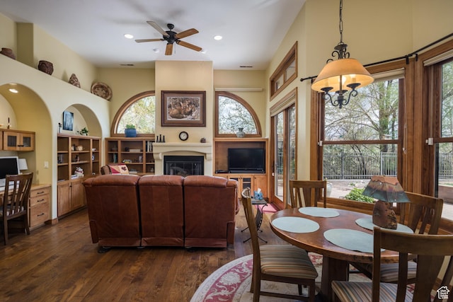 3270 E Rim Vistas Cir, Moab, UT 84532 - dining area featuring dark wood-type flooring, a glass covered fireplace, ceiling fan, and recessed lighting