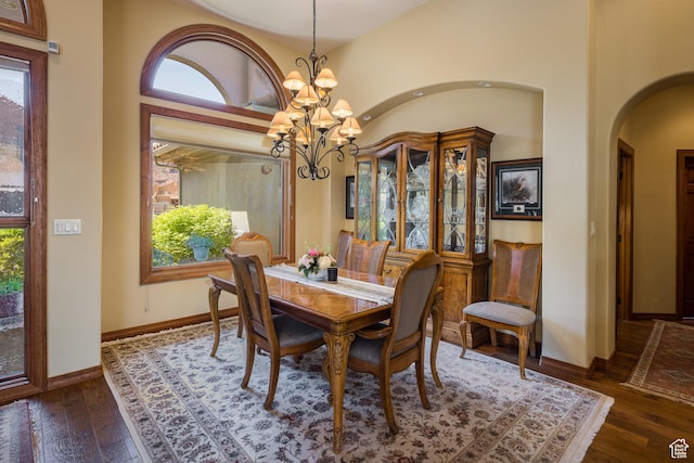 3270 E Rim Vistas Cir, Moab, UT 84532 - dining area with dark wood finished floors, arched walkways, an inviting chandelier, and plenty of natural light