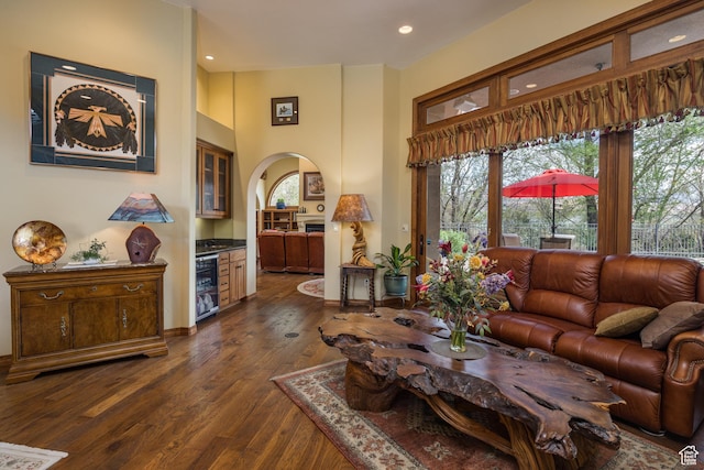 3270 E Rim Vistas Cir, Moab, UT 84532 - living room with dark wood-style floors, arched walkways, a healthy amount of sunlight, and wine cooler