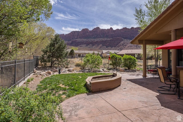 3270 E Rim Vistas Cir, Moab, UT 84532 - view of yard with a fenced backyard, a mountain view, and a patio area