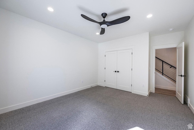 unfurnished bedroom featuring recessed lighting, dark carpet, and baseboards