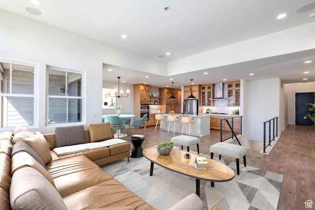 living area featuring an inviting chandelier, light wood finished floors, and recessed lighting
