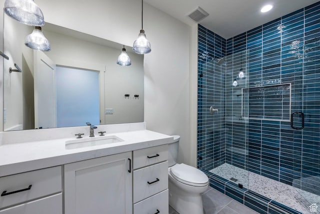 bathroom featuring a shower stall, toilet, vanity, and visible vents