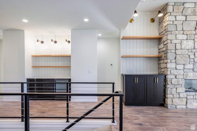 unfurnished dining area featuring wooden walls and wood finished floors