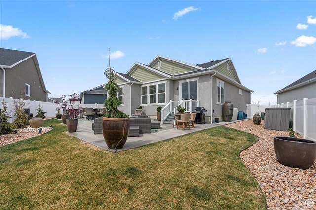 6079 W Teton Village Dr Unit 106, Herriman, UT 84096 - rear view of house featuring a lawn, a fenced backyard, and a patio area