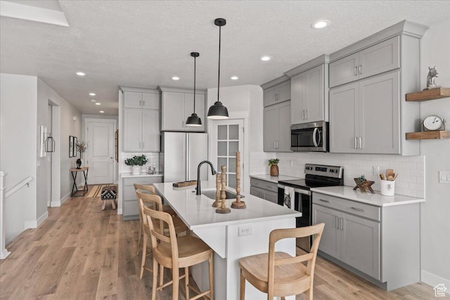 6079 W Teton Village Dr Unit 106, Herriman, UT 84096 - kitchen featuring gray cabinets, appliances with stainless steel finishes, open shelves, and a sink