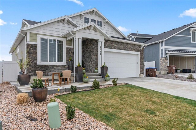 6079 W Teton Village Dr Unit 106, Herriman, UT 84096 - craftsman-style home with an attached garage, driveway, stone siding, and a front yard