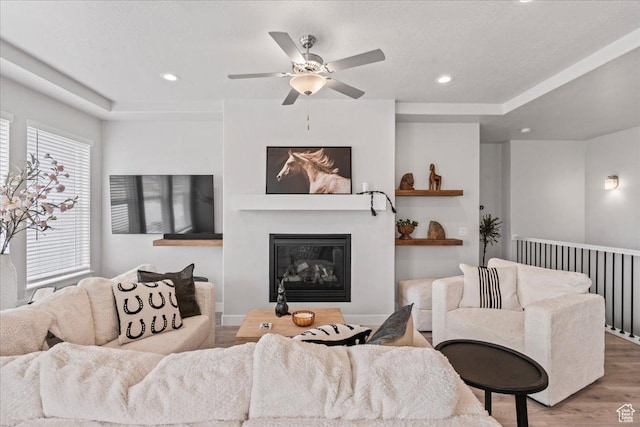 6079 W Teton Village Dr Unit 106, Herriman, UT 84096 - living room featuring a glass covered fireplace, a ceiling fan, wood finished floors, and recessed lighting