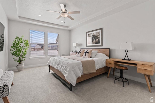 6079 W Teton Village Dr Unit 106, Herriman, UT 84096 - bedroom featuring light carpet, a tray ceiling, a textured ceiling, baseboards, and ceiling fan