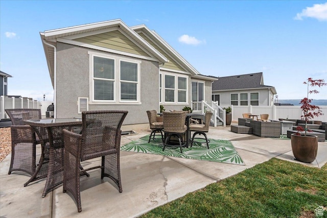 6079 W Teton Village Dr Unit 106, Herriman, UT 84096 - back of property featuring outdoor dining space, a patio area, stucco siding, and an outdoor living space