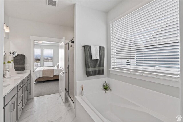 6079 W Teton Village Dr Unit 106, Herriman, UT 84096 - ensuite bathroom featuring a sink, visible vents, marble finish floor, a garden tub, and connected bathroom