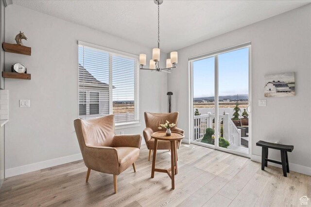 6079 W Teton Village Dr Unit 106, Herriman, UT 84096 - sitting room featuring a chandelier, light wood-style flooring, and baseboards