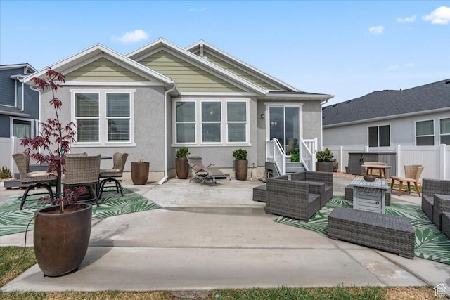 6079 W Teton Village Dr Unit 106, Herriman, UT 84096 - back of house featuring stucco siding, outdoor lounge area, fence, and a patio