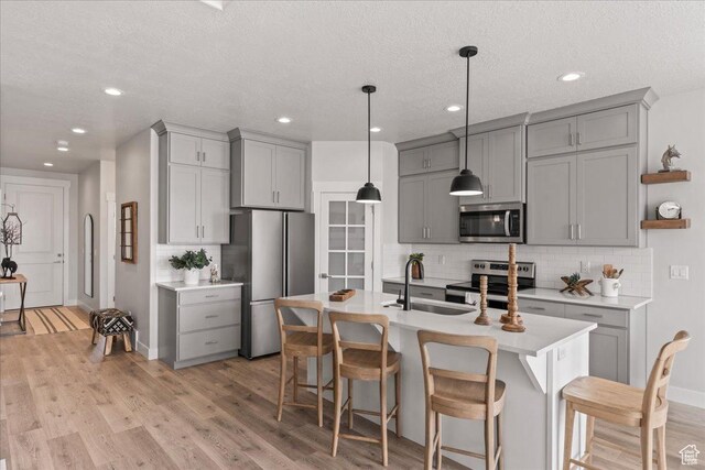 6079 W Teton Village Dr Unit 106, Herriman, UT 84096 - kitchen with light countertops, gray cabinets, stainless steel appliances, and a sink