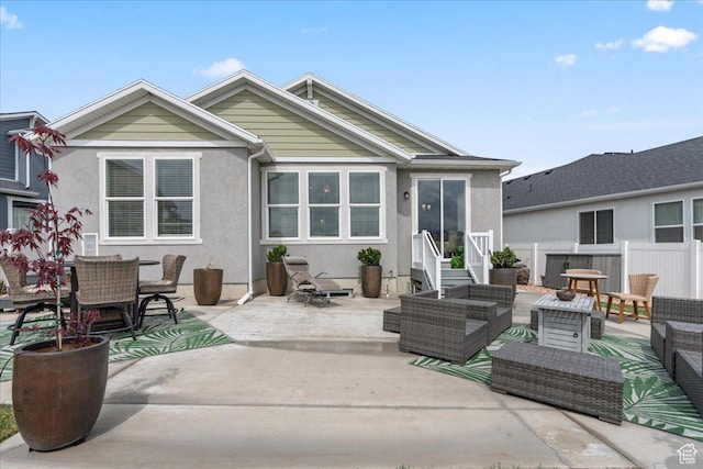 6079 W Teton Village Dr Unit 106, Herriman, UT 84096 - back of house with stucco siding, fence, a patio area, and an outdoor hangout area