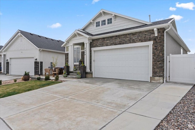 6079 W Teton Village Dr Unit 106, Herriman, UT 84096 - view of front of property featuring driveway, stone siding, and a garage