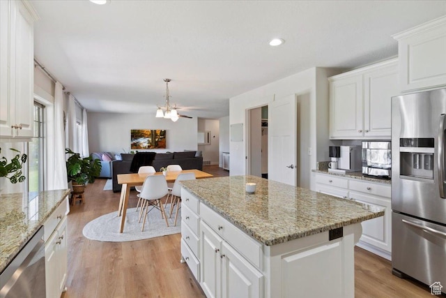 2292 W 440 S, Provo, UT 84601 - kitchen with light wood finished floors, an inviting chandelier, a kitchen island, appliances with stainless steel finishes, and open floor plan