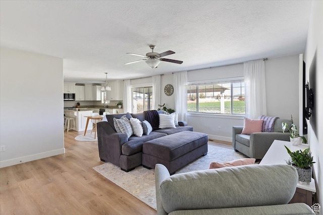 2292 W 440 S, Provo, UT 84601 - living area featuring a ceiling fan, baseboards, and light wood-style floors