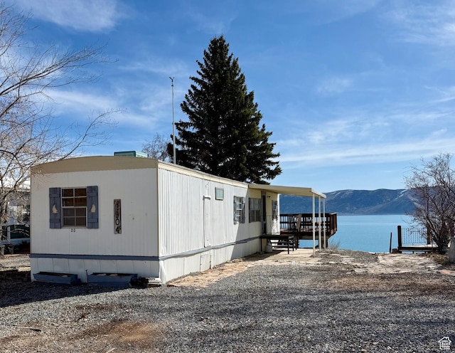exterior space with a water and mountain view