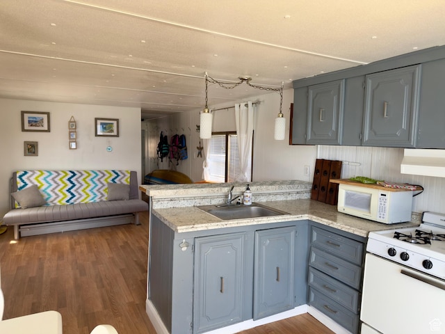 2904 S Edgemont Dr, Garden City, UT 84028 - kitchen featuring white appliances, a peninsula, extractor fan, wood finished floors, and gray cabinetry