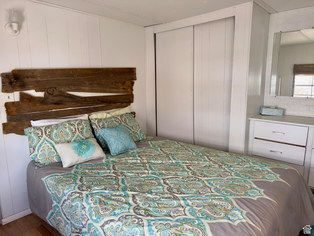 2904 S Edgemont Dr, Garden City, UT 84028 - bedroom featuring a closet and wood walls