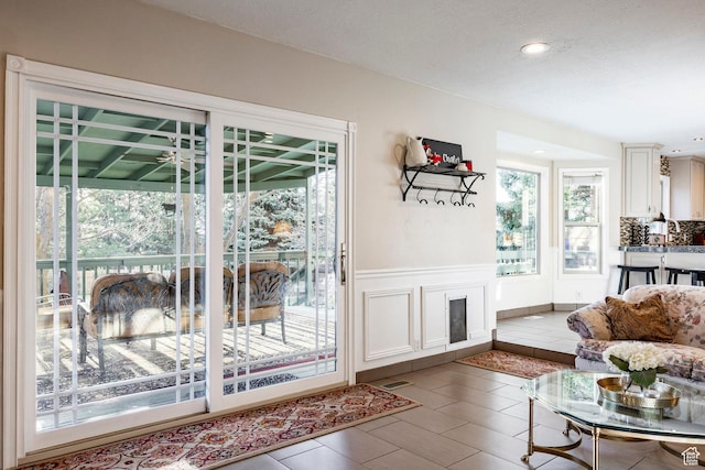 doorway featuring a wainscoted wall and recessed lighting