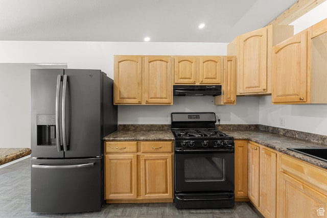kitchen with dark countertops, black gas range, under cabinet range hood, and stainless steel fridge with ice dispenser