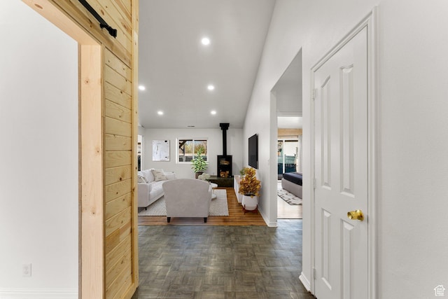 hall featuring baseboards and recessed lighting