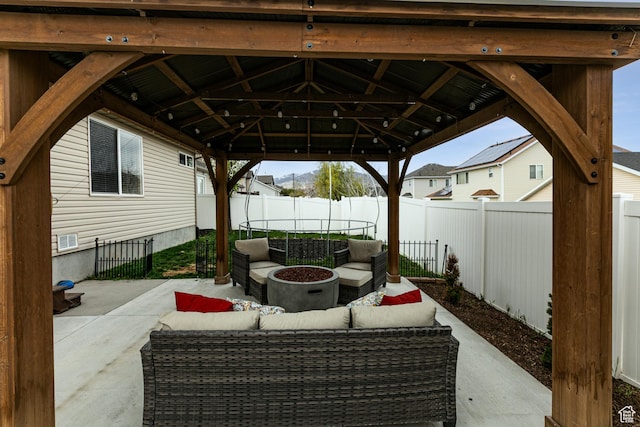6576 W Oak Bridge Dr, West Jordan, UT 84081 - fenced backyard featuring a patio, outdoor lounge area, and a trampoline