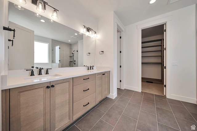 1910 W Bonneville Ln, Kaysville, UT 84037 - bathroom featuring a shower stall, a sink, double vanity, baseboards, and tile patterned flooring