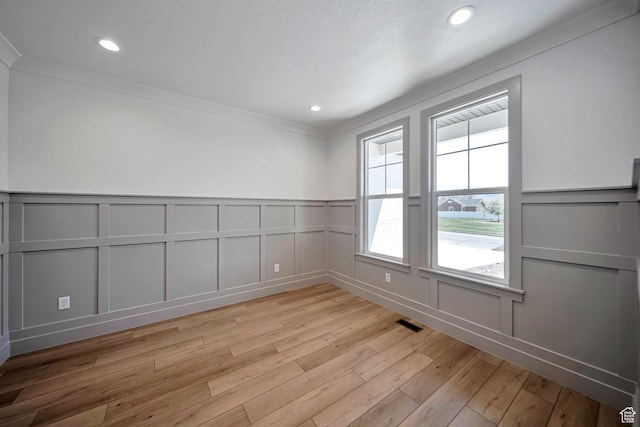 1910 W Bonneville Ln, Kaysville, UT 84037 - unfurnished room featuring visible vents, a decorative wall, and light wood-type flooring