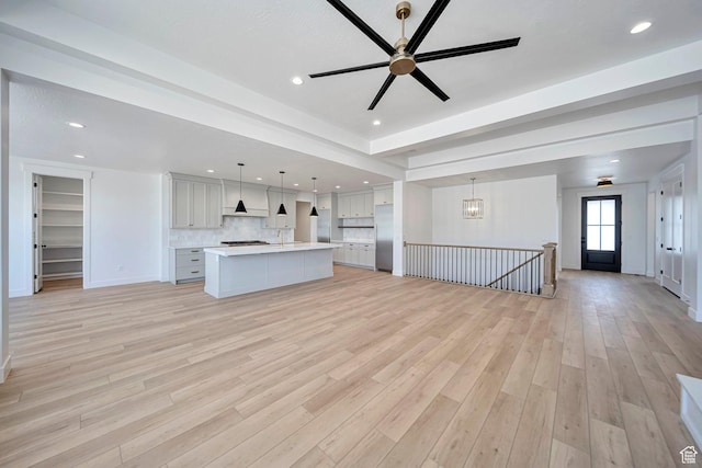 1910 W Bonneville Ln, Kaysville, UT 84037 - unfurnished living room featuring baseboards, recessed lighting, a ceiling fan, and light wood-style flooring