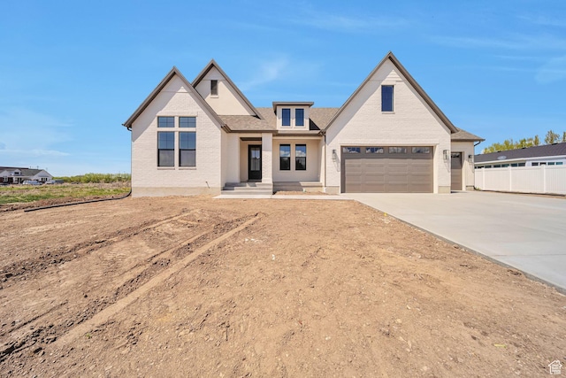 1910 W Bonneville Ln, Kaysville, UT 84037 - view of front facade featuring brick siding, fence, and concrete driveway