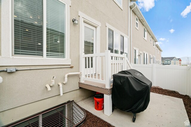 view of patio / terrace with a grill and fence