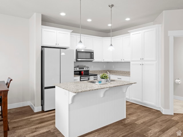 kitchen with white cabinets, dark wood-style floors, a sink, baseboards, and appliances with stainless steel finishes