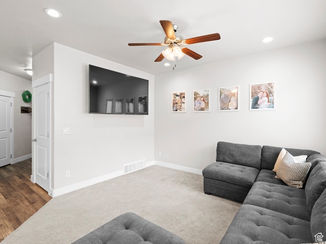 carpeted living room featuring ceiling fan, baseboards, visible vents, and recessed lighting