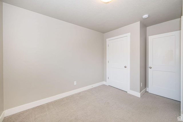 2276 W 2625 S Unit 110, West Haven, UT 84401 - unfurnished bedroom featuring baseboards and light carpet