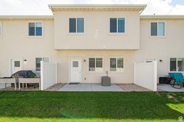 2276 W 2625 S Unit 110, West Haven, UT 84401 - rear view of house with stucco siding, cooling unit, a patio, and a lawn