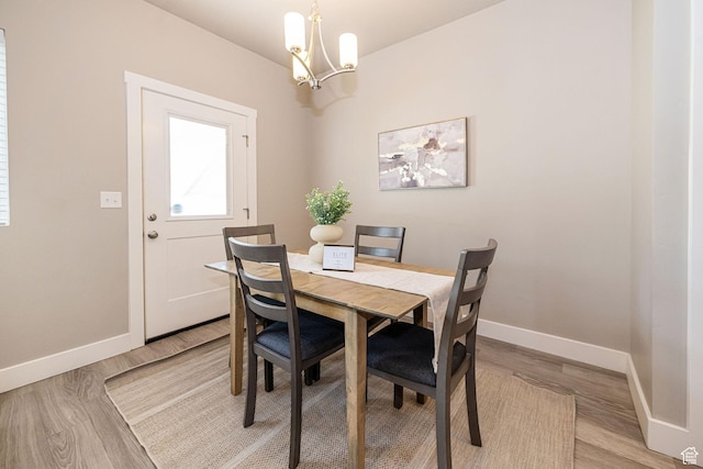 2276 W 2625 S Unit 110, West Haven, UT 84401 - dining room with baseboards, light wood-style flooring, and an inviting chandelier