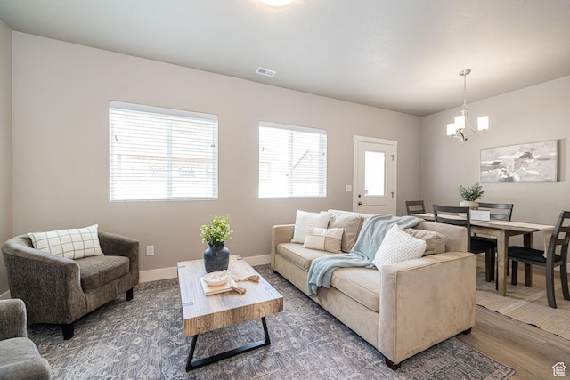 2276 W 2625 S Unit 110, West Haven, UT 84401 - living area featuring baseboards, wood finished floors, a chandelier, and visible vents