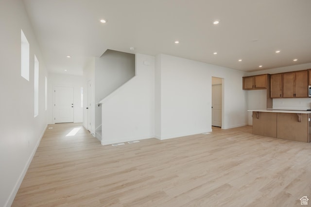 3651 N Oak Blvd Unit 337, Eagle Mountain, UT 84005 - unfurnished living room featuring baseboards, recessed lighting, stairway, and light wood finished floors