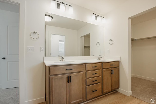 3651 N Oak Blvd Unit 337, Eagle Mountain, UT 84005 - full bath with double vanity, a walk in closet, baseboards, and a sink