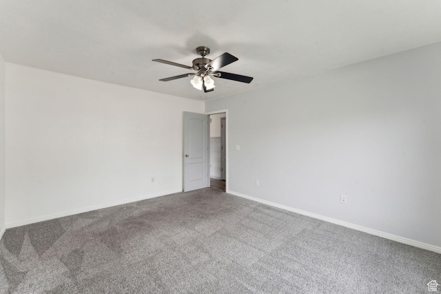 carpeted empty room featuring ceiling fan and baseboards