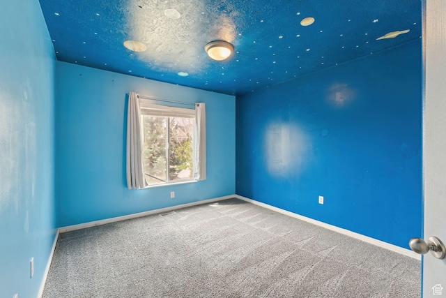 empty room with visible vents, baseboards, and carpet floors
