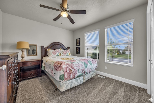 bedroom with visible vents, a ceiling fan, baseboards, and carpet floors