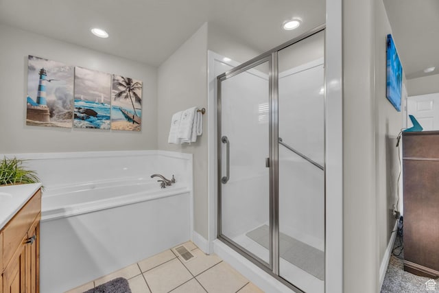 bathroom with a bath, a stall shower, recessed lighting, tile patterned flooring, and vanity
