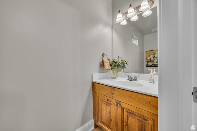 bathroom featuring baseboards, visible vents, and vanity