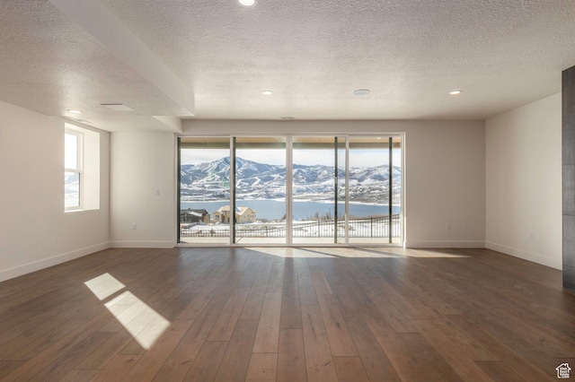 496 E Kayak Dr Unit 306, Hideout, UT 84036 - empty room with wood-type flooring, a textured ceiling, and baseboards